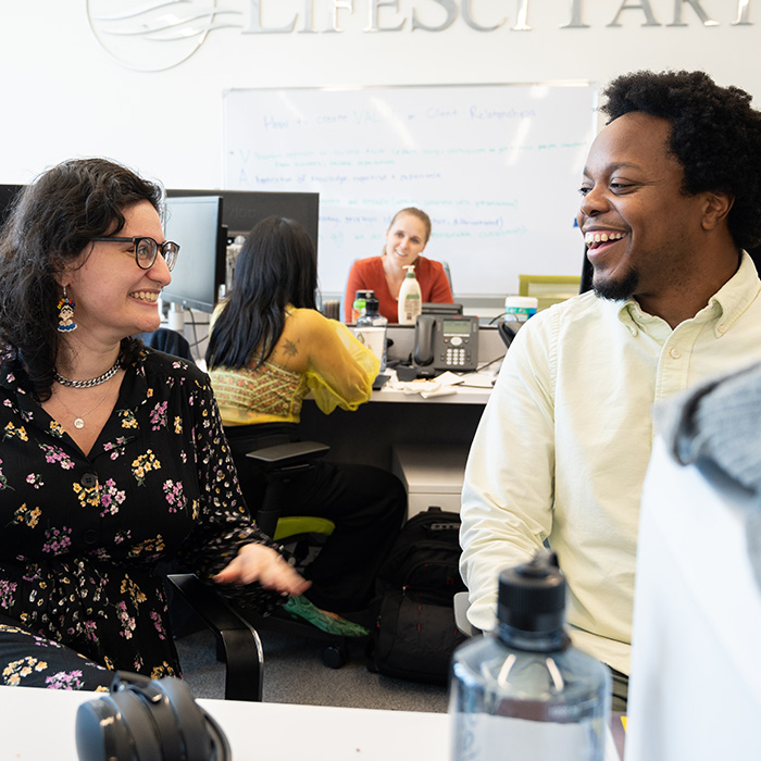 Employees smiling in the Life Sci Communications office - Get In Touch