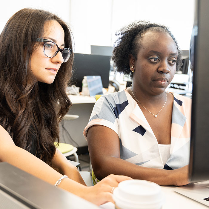 kristin politi and gloria gasaatura working in the LifeSci Communcations office - our capabilities